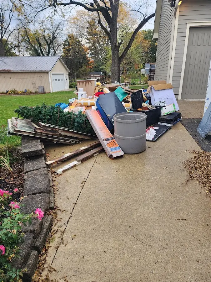 Dumpster being loaded with debris for Roofing Dumpster Rental in McSwain